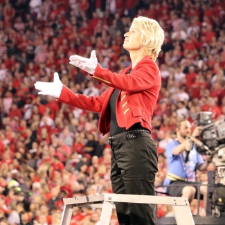 photo of conductor on platform at sporting event