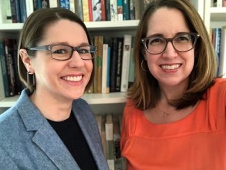 photo of two women in front of bookshelf