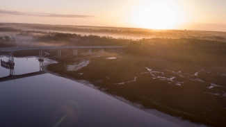 aerial photo of a coastal marsh, with bridge