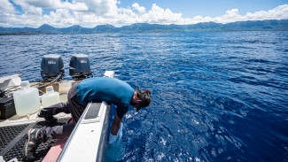 photo of man in boat in the ocean