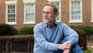 photo of man, with building in background