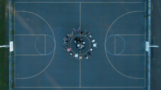 photo of basketball court with people at the center, from above