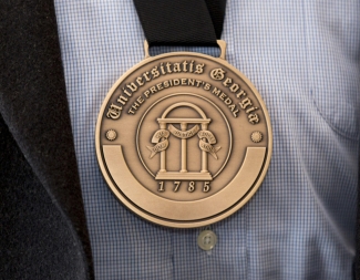 photo of engraved medal, shirt and jacket