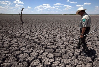 man walking on dried ground