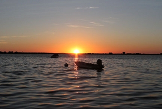 sunset with boat and water