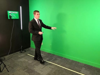 photo of man in suit with green wall