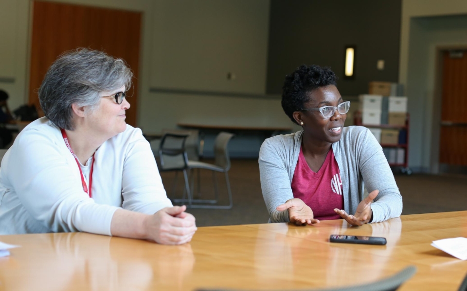 Jill Severn, Russell Library Archivist, red lanyard, and Dr. Amma Y. Ghartey-Tagoe Kootin. Image by Shannah Montgomery