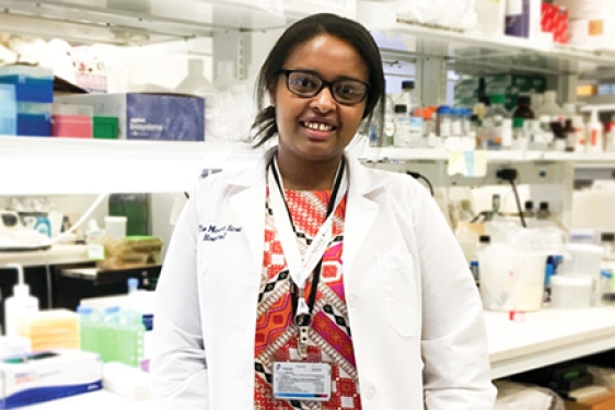 woman in white coat in lab