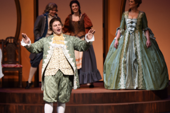 photo of singers in 19th century costumes on stage