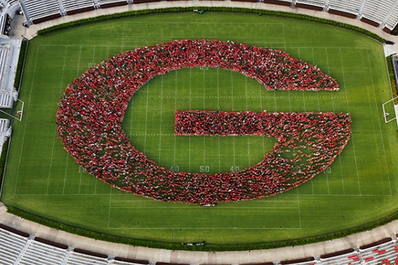 drone aerial photo of people making letter G in stadium