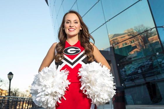 photo of cheerleader in front of coliseum