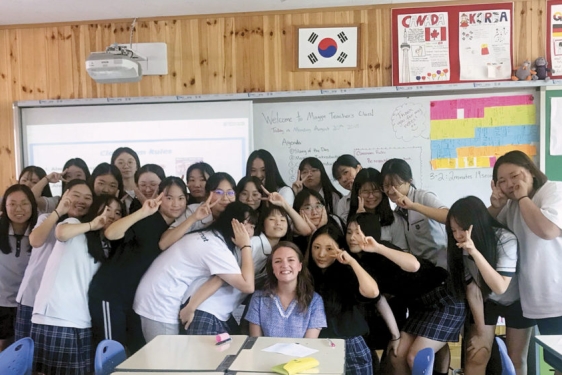 photo of woman with students in classroom