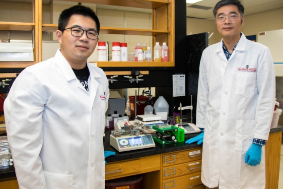 Photo of two men in lab coats