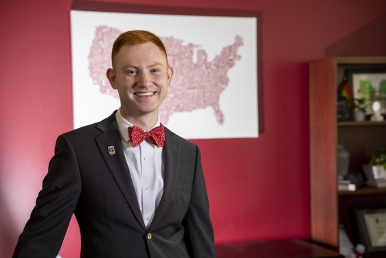 photo of man, map on wall in background