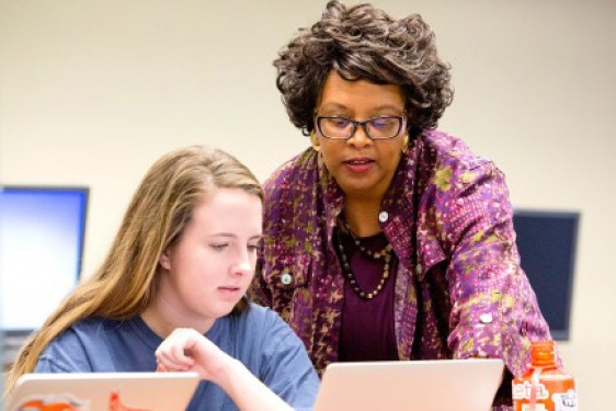 professor with student on computer 