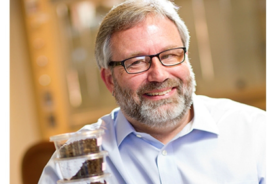 man in lab with plastic containers