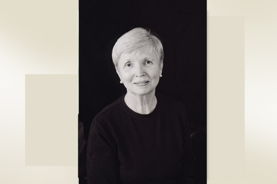 headshot of woman on black back ground with color block