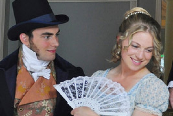 smiling man, woman with fan