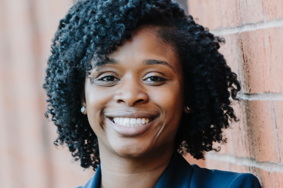 headshot of photo woman, with wall