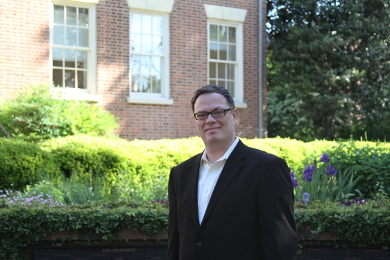 photo of man outdoors adjacent to brick building