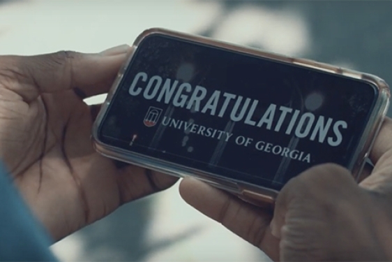 photo of hands holding a cell phone with congratulations