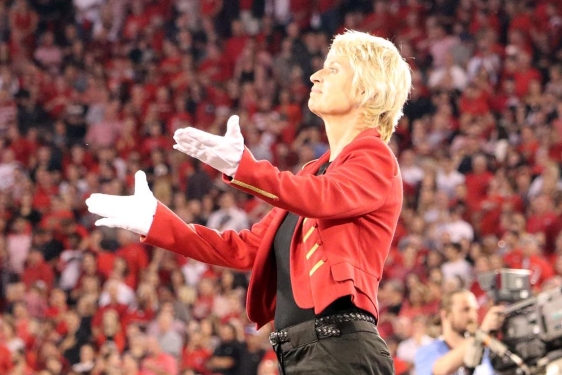 photo of conductor on platform at sporting event