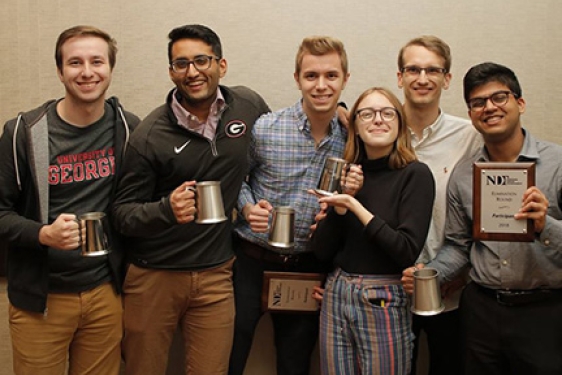 photo of six students holding award cups