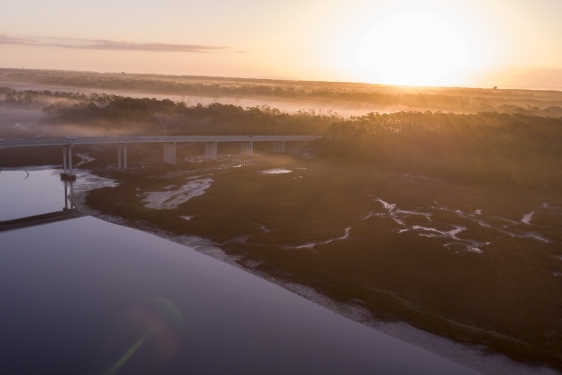 aerial photo of a coastal marsh, with bridge