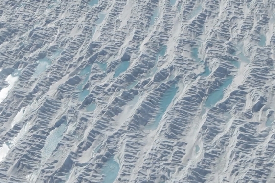 aerial photo of water puddles on glacier