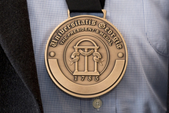 photo of engraved medal, shirt and jacket