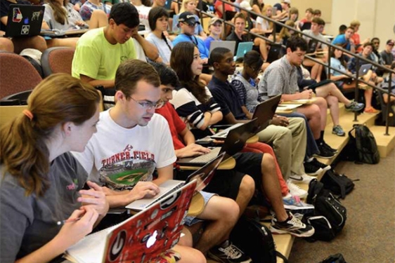 photo of students auditorium classroom with laptops