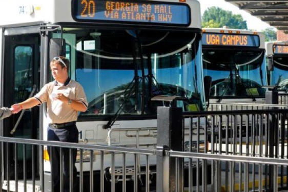 man in front of buses