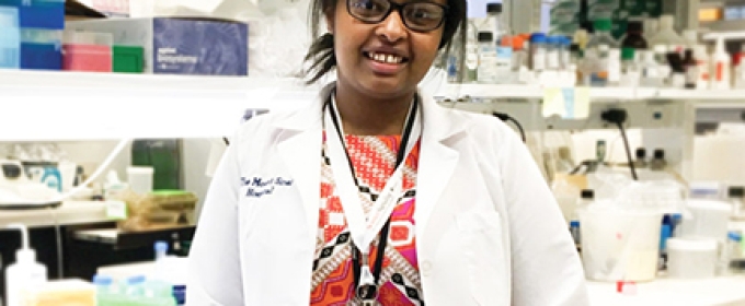 woman in white coat in lab