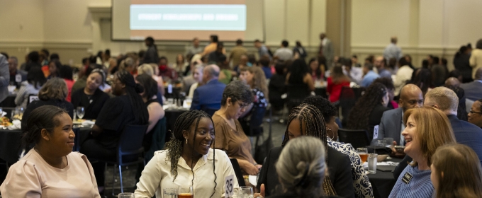 photo of people seated at tables at luncheon