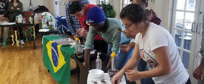 photo of students with table, flag and food