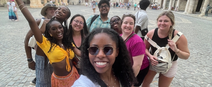 photo of group of people, classical architecture in background, day