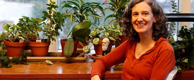 photo of woman in office, seated with window