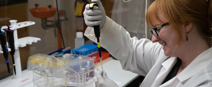 photo of woman with pipette and white coat