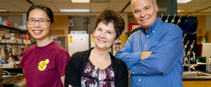 photo of three people in a laboratory 