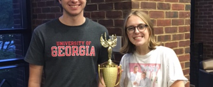 man and woman with trophy