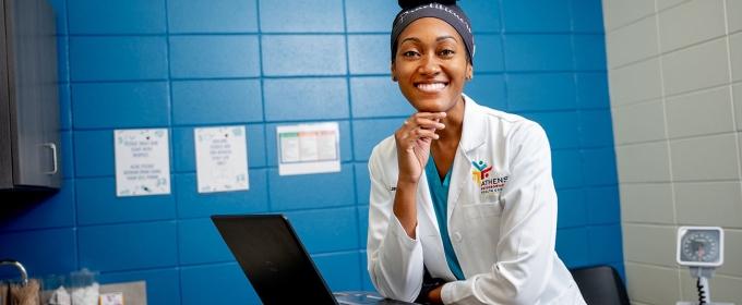 photo of woman with laptop in exam room