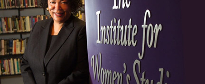 photo of woman with wall and books