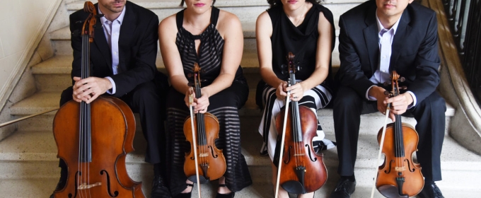 photo of four musicians seated on steps