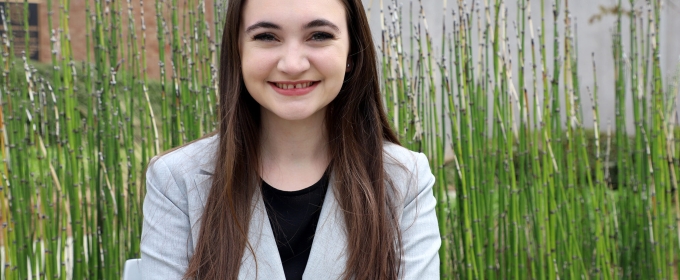 photo of woman, outdoors with bamboo reeds in background