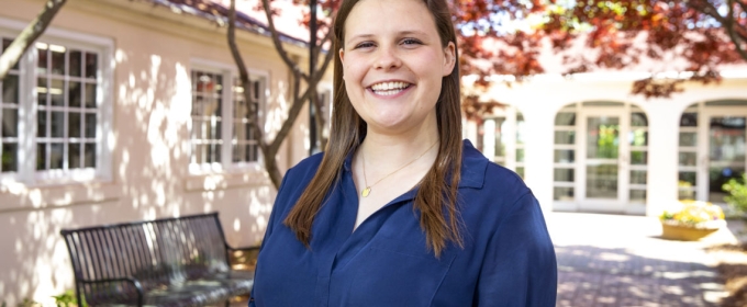 photo of woman outside of building with trees