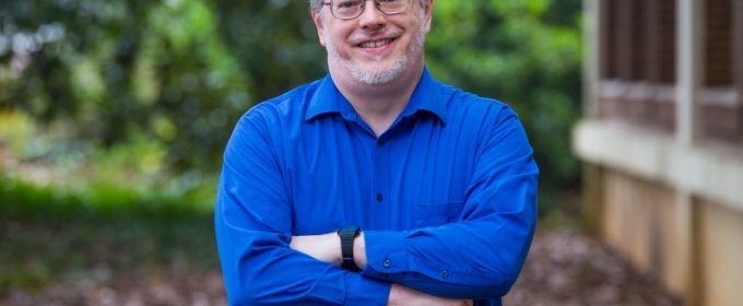 photo of man in blue shirt, outdoors