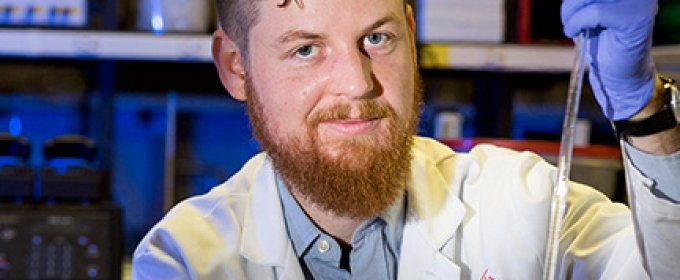 man in lab with syringe 