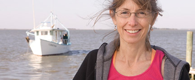 woman outside with water, boat