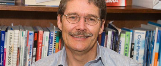 photo of man with bookshelves