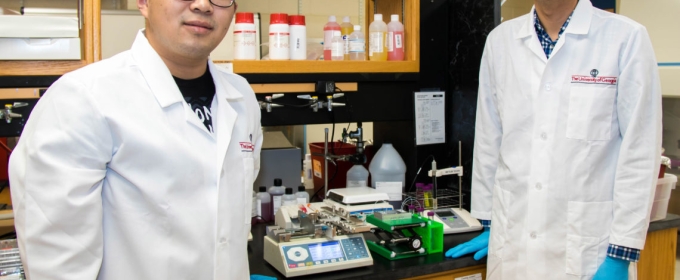 Photo of two men in lab coats